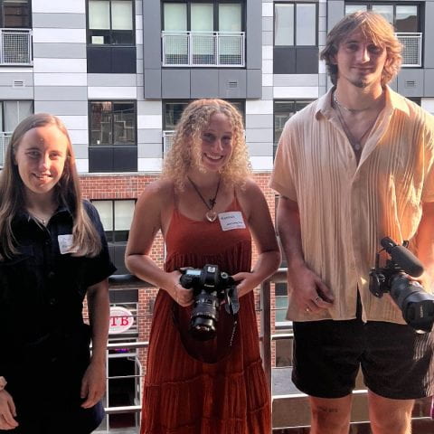CREA marketing interns Amy Milner, Hannah Gard-Wise, and Derek Slywka pose for a photo on the balcony at Rev: Ithaca Startup Works.
