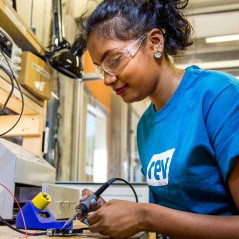 Woman working in hardware shop at Rev: Ithaca Startup Works.
