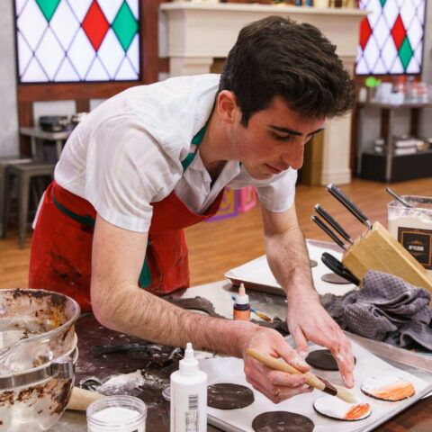 Jonah Gershon decorating Christmas cookies.